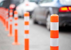 Orange bollard on the road. Traffic jam.